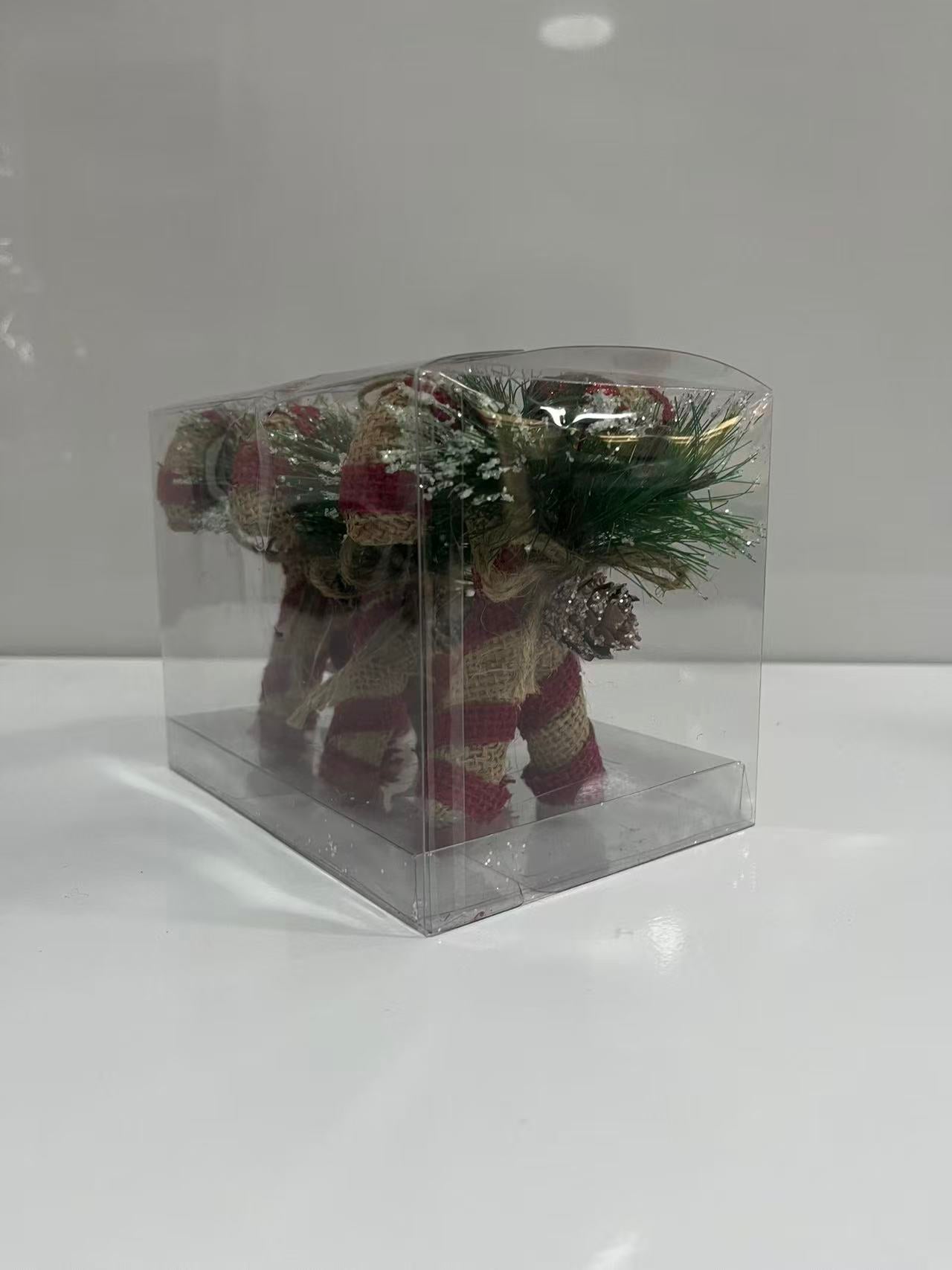 Set of 3 rustic Christmas reindeer ornaments made from two candy canes, featuring red and white striped burlap, artificial pine needles, and pine cones in a transparent PVC gift box.