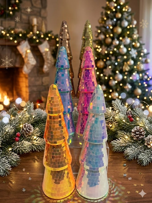 Wholesale collection of iridescent and metallic disco ball mirror tile Christmas trees in a vertical display with cozy fireplace and festive bokeh background.